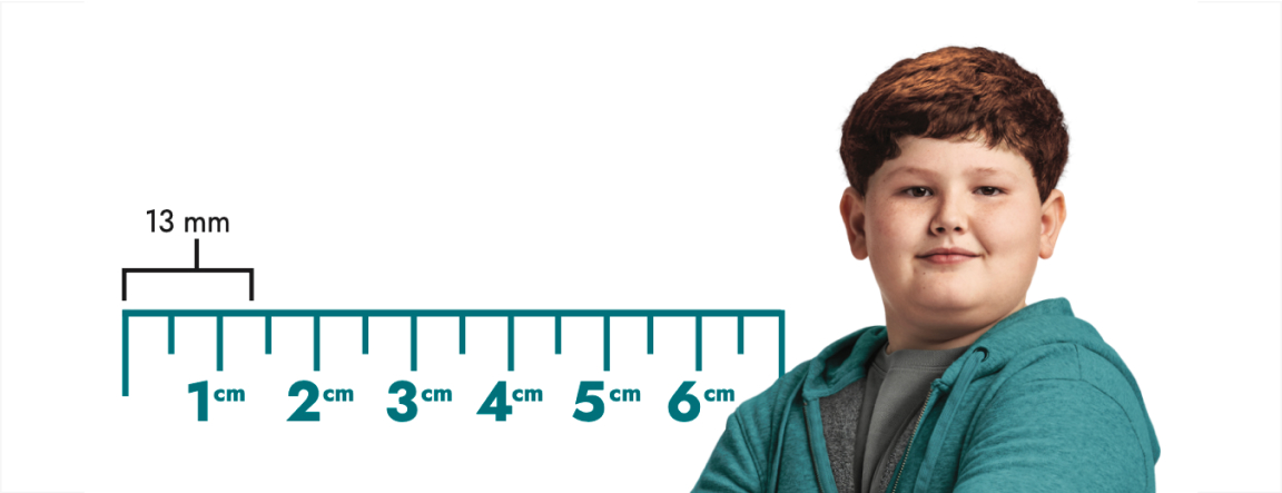 Frame-25 A boy stands beside a ruler marked with numbers ranging from 1cm to 6 cm. A measurement of 13mm is labelled above the ruler.